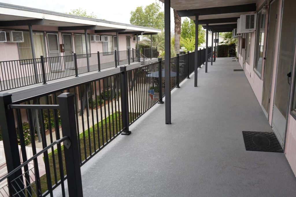 Concrete apartment walkway with fresh waterproofing membrane in Sacramento