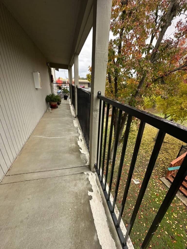 Apartment building exterior elevated walkway during SB 721 compliance inspection