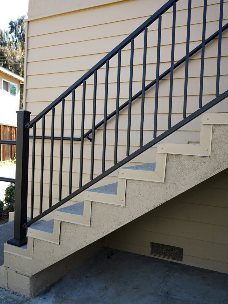 Replaced steel guard rails on an apartment building exterior staircase