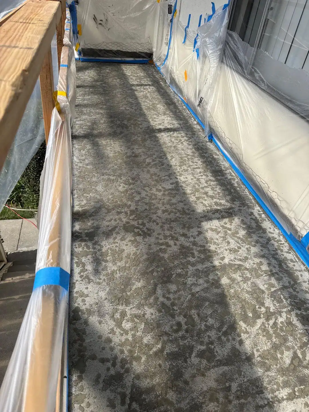 Balcony deck masked off and prepped before a new waterproofing membrane is applied