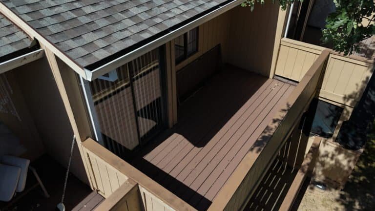 Aerial view of a townhome balcony re-decked in charcoal Trex composite with a light grey border