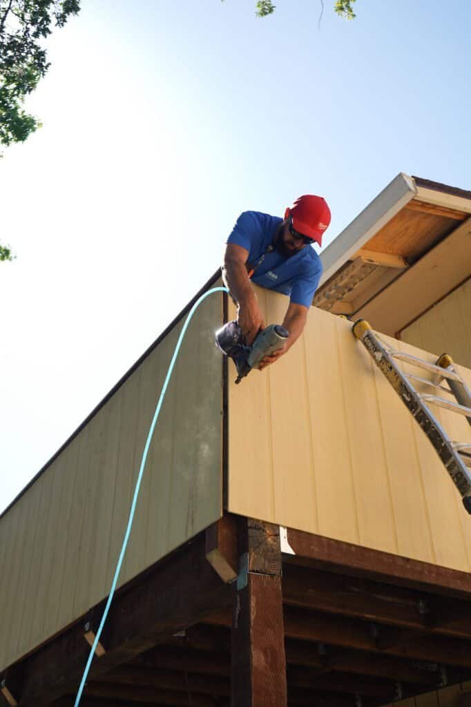 The same balcony structure after framing repairs and repaint, with no rot or splitting left