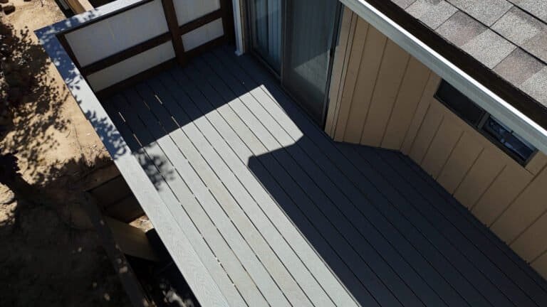 Corner of a rebuilt balcony showing the two-tone Trex border detail