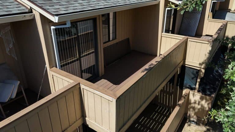 Two adjoining townhome balconies with new composite decking and capped privacy walls