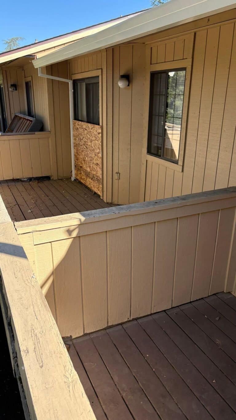Weathered balcony decking and privacy wall before the deck was pulled