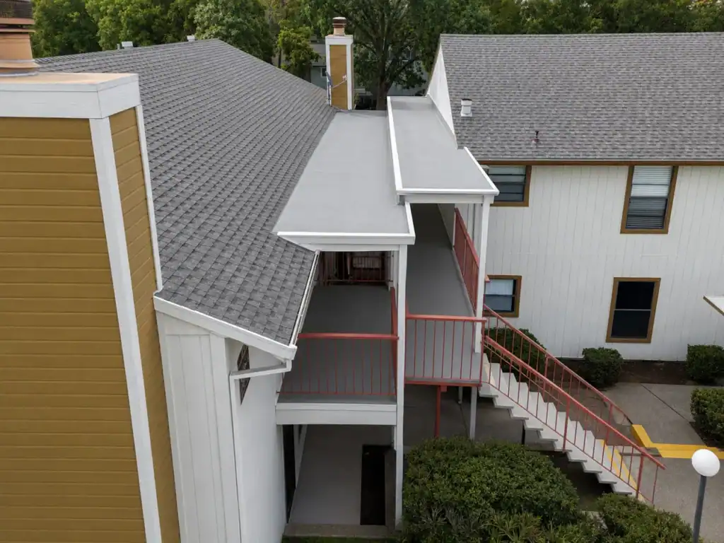 Aerial view of the rebuilt low-slope walkway roof with new membrane and edge metal