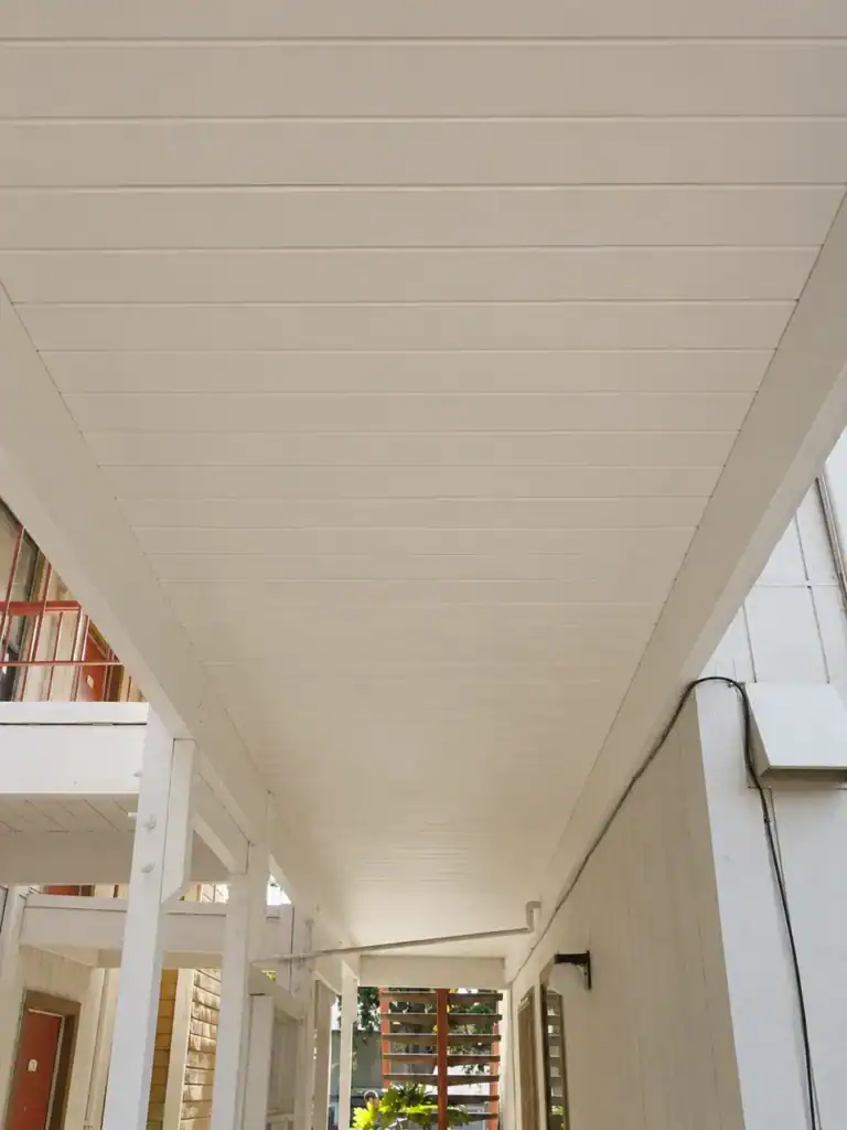 The same soffit after damaged boards were replaced and the ceiling repainted