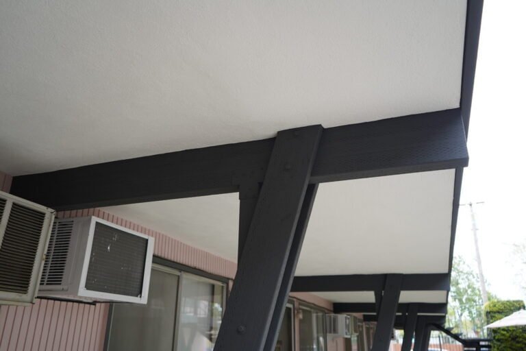 Repainted steel beam and brace connection under a rebuilt elevated walkway