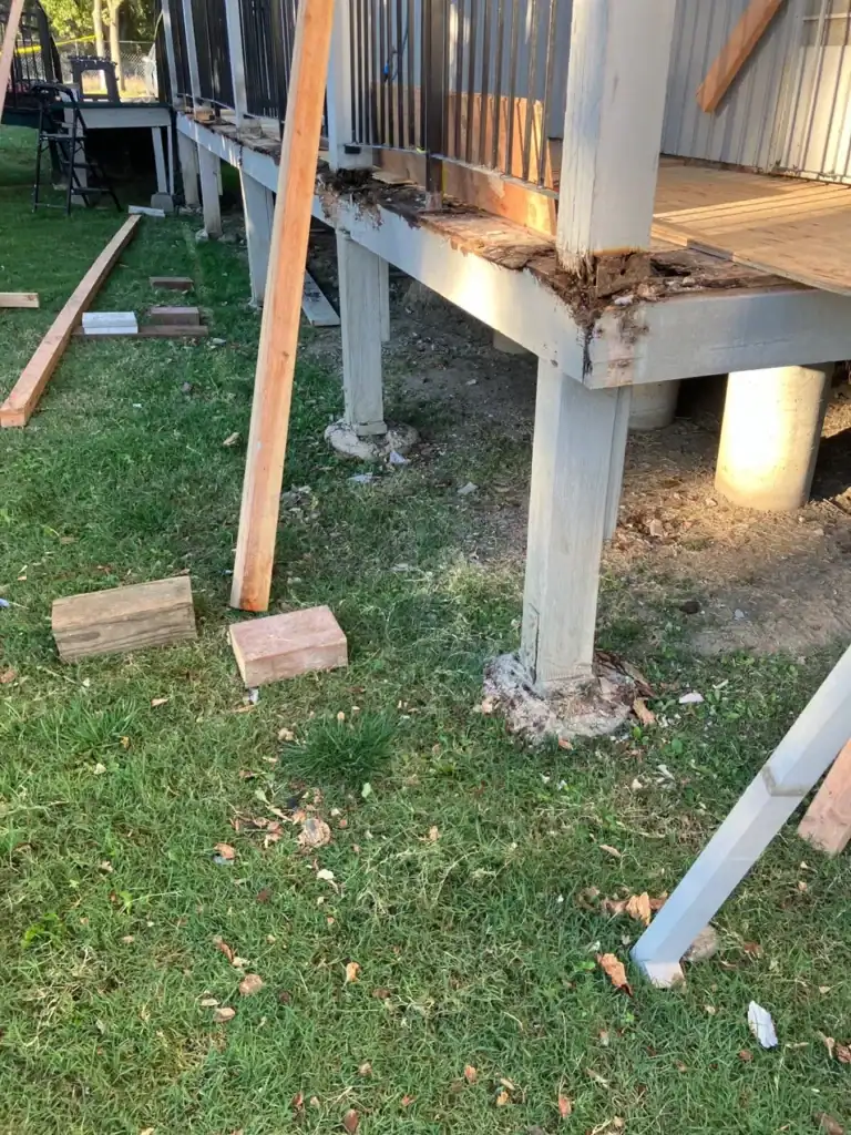 Dry rot at the post and rim joist connection of an apartment deck during structural repair in Rio Linda