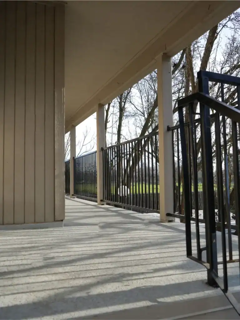Waterproofed apartment walkway and stair gate with new non-slip deck coating