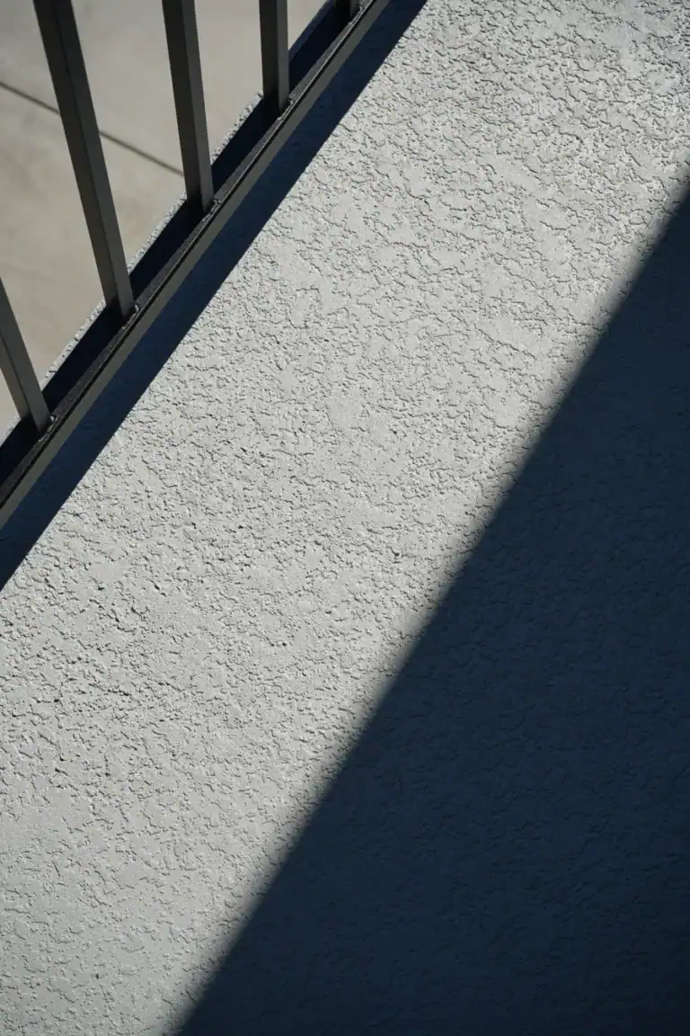 Close view of the textured waterproof deck finish at the guardrail base