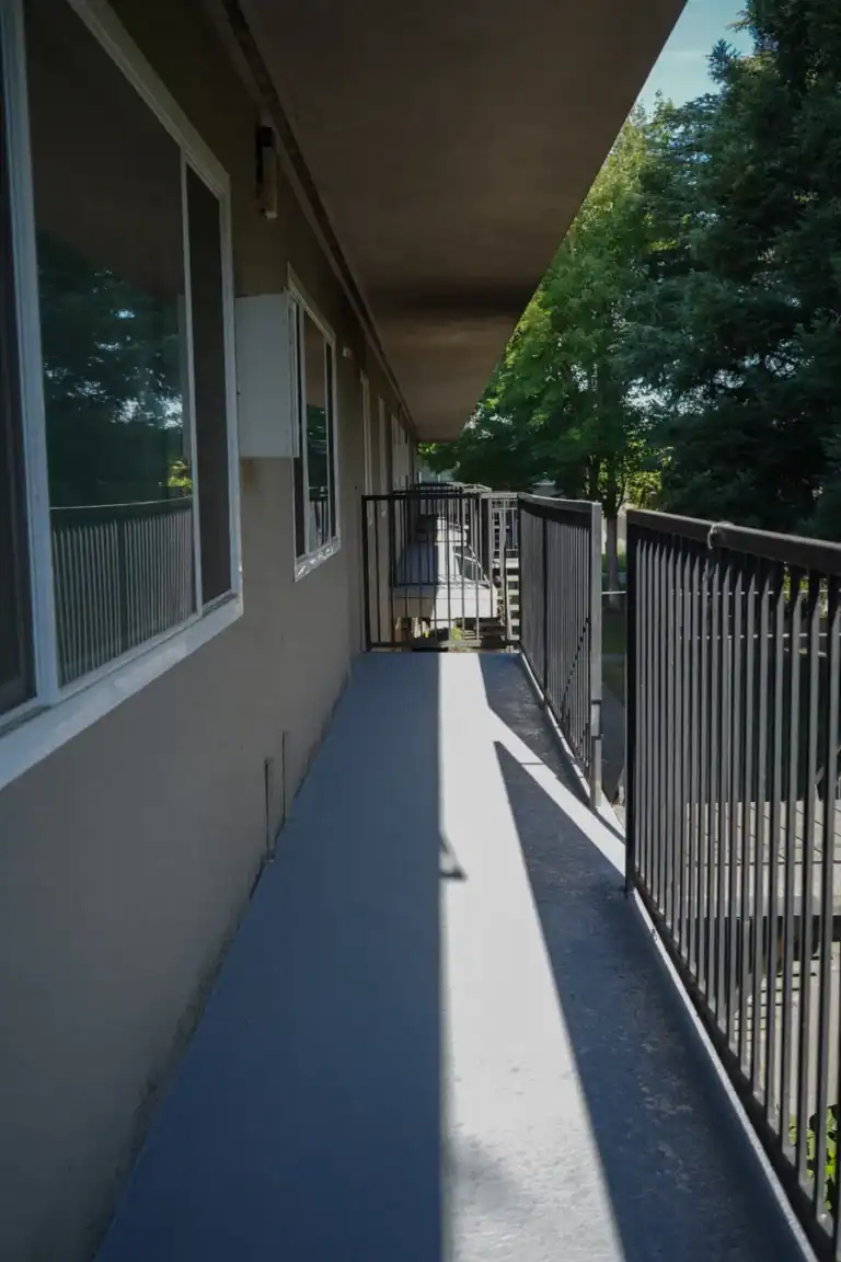 Waterproof membrane coating applied across an elevated apartment walkway