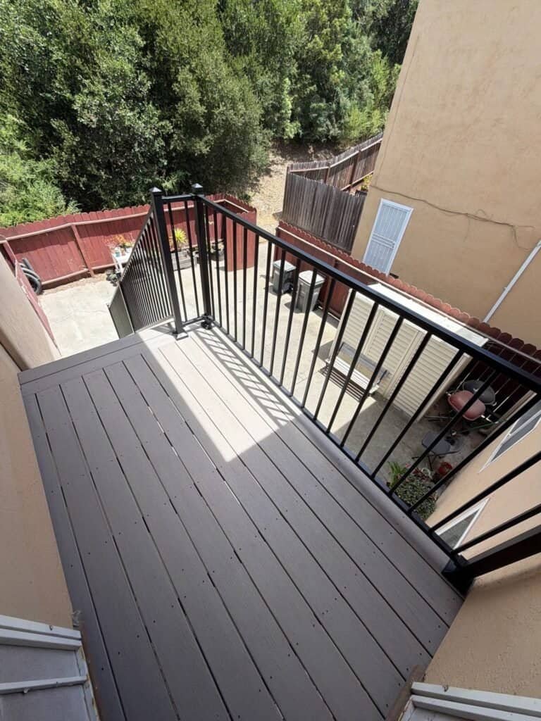 Rebuilt apartment landing in Oakland seen from above, composite decking over the courtyard