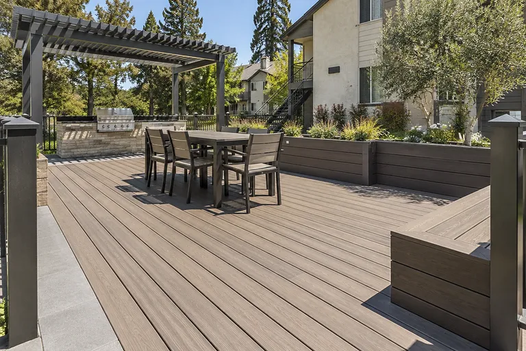 Sacramento deck builders — rebuilt garden-style apartment deck with dining area and planter walls