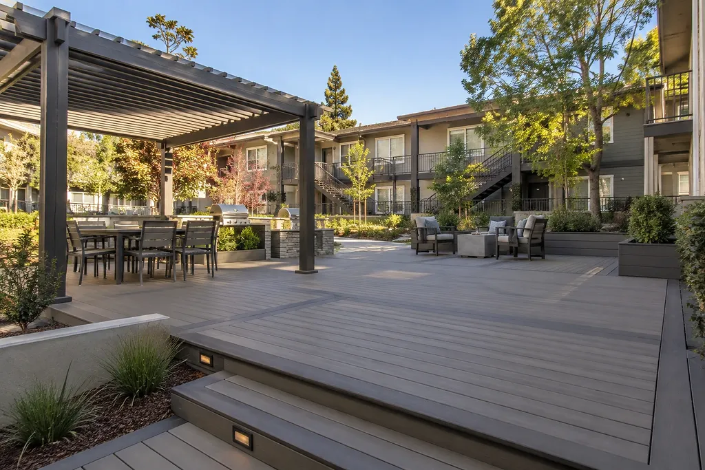 Deck builders Sacramento CA — rebuilt community deck with pergola, bench seating and lighted stairs