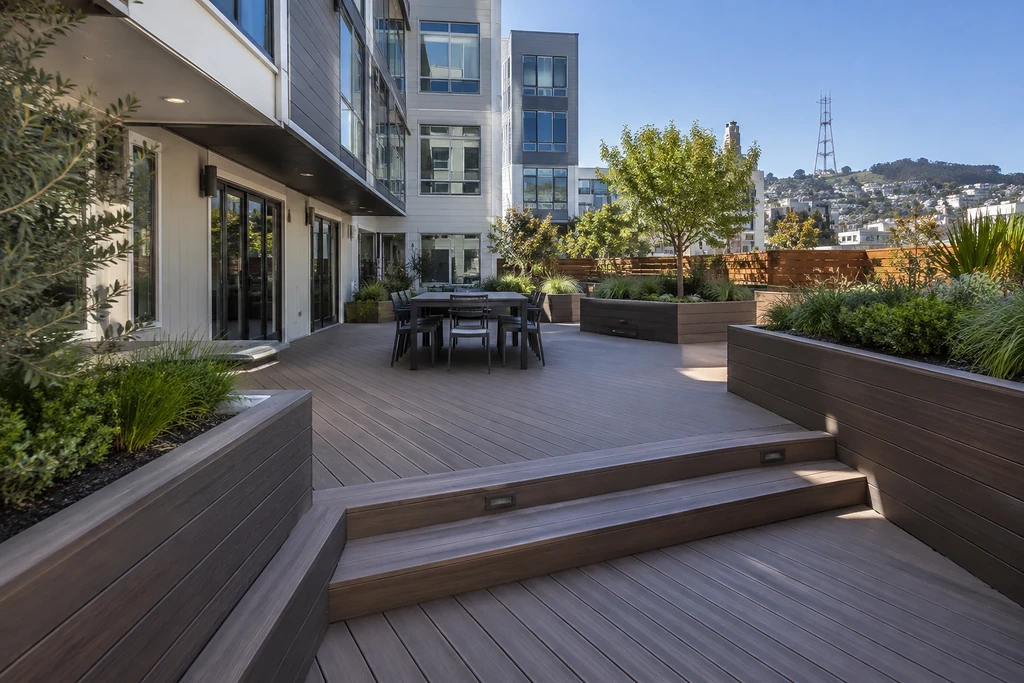 San Francisco deck builders — podium courtyard deck with planters and lighted steps below Sutro Tower