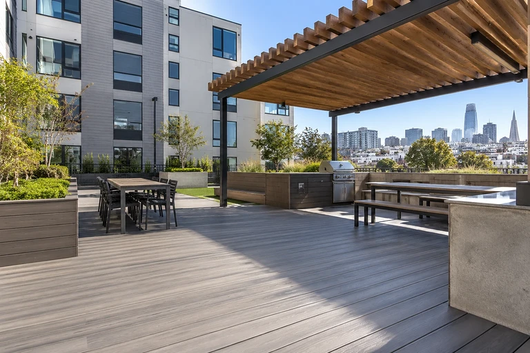 Building a roof deck in San Francisco — rooftop terrace with timber pergola, outdoor kitchen and city skyline