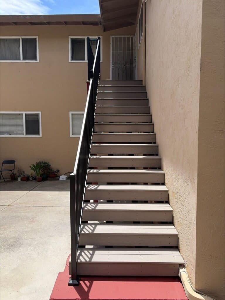 Apartment stair in Oakland with Trex composite treads and a new aluminum guardrail