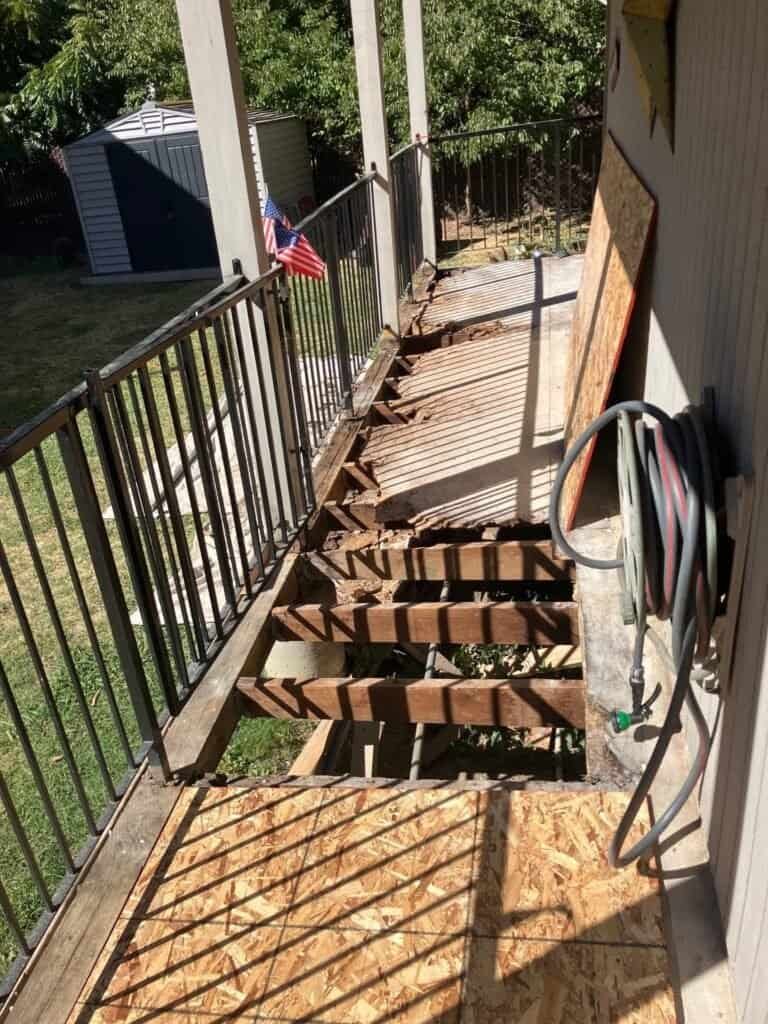 Rio Linda apartment walkway with the decking removed, exposing the joists before framing repairs