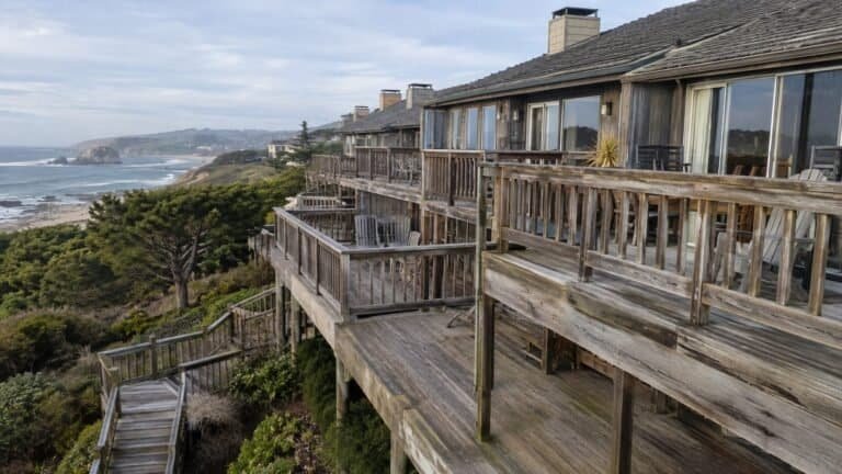 Multi-level weathered ocean-view decks stepping down a bluff-top property in San Mateo before replacement