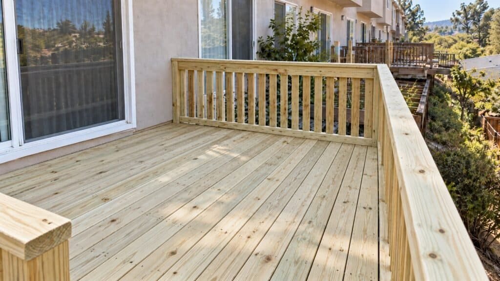 Rebuilt townhome deck with new pressure-treated decking and matching railing after replacement in San Ramon
