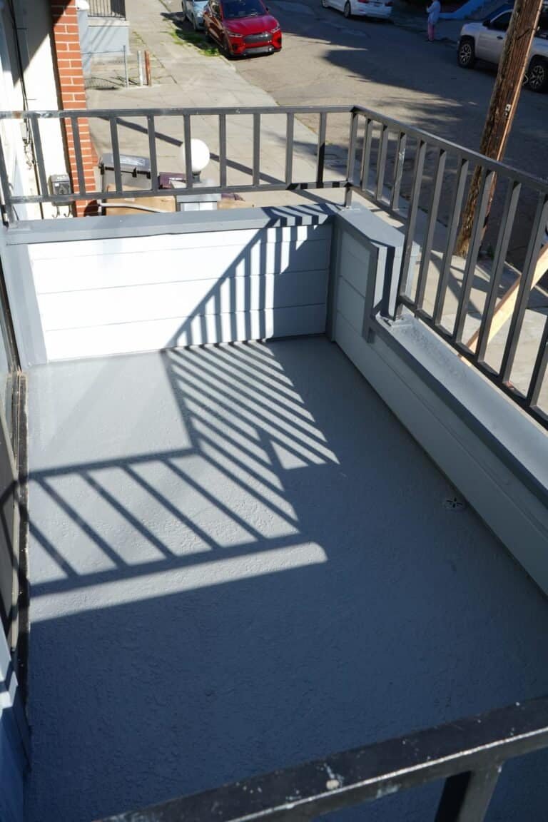 Vacaville apartment balcony finished with a grey textured waterproof deck coating above the street