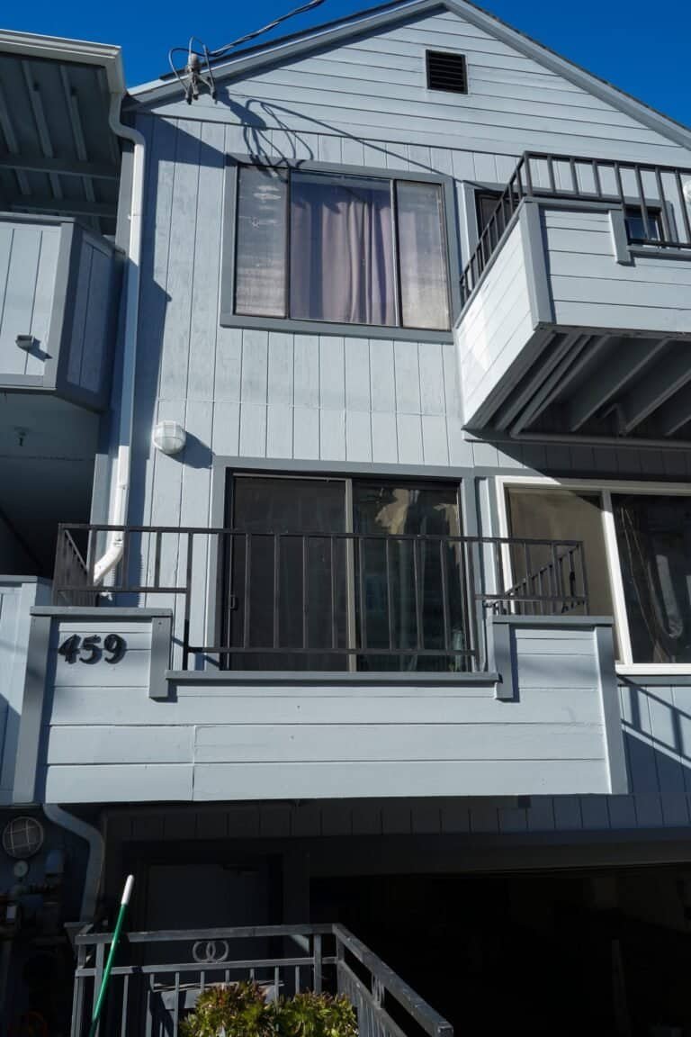 Blue board-and-batten apartment building in Vacaville with rebuilt balconies after waterproofing