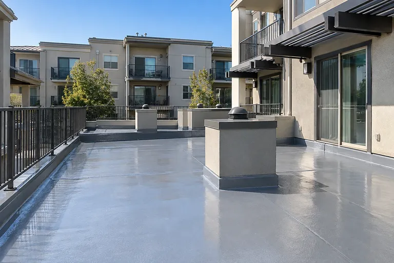Deck waterproofing Sacramento — coated podium terrace over parking at a mixed-use building