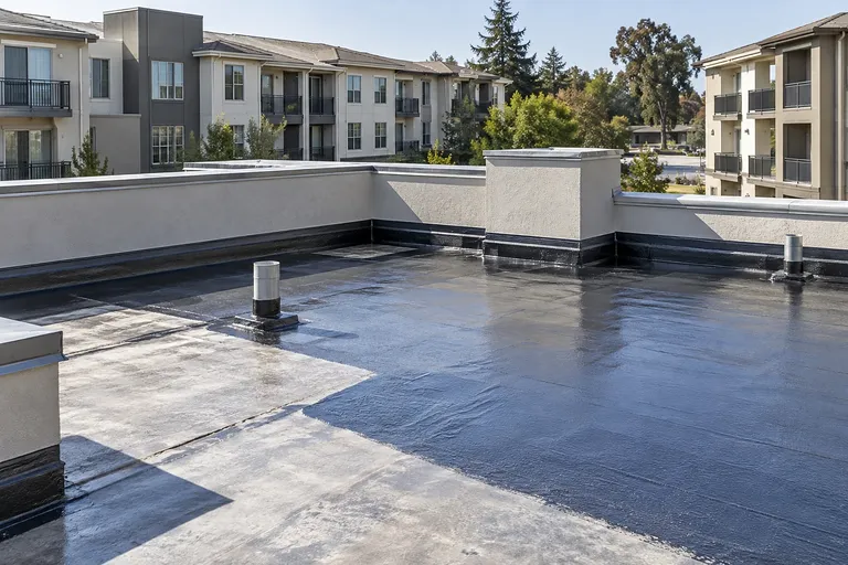 Waterproof decks Sacramento — coated roof terrace with flashed mechanical penetrations and parapet