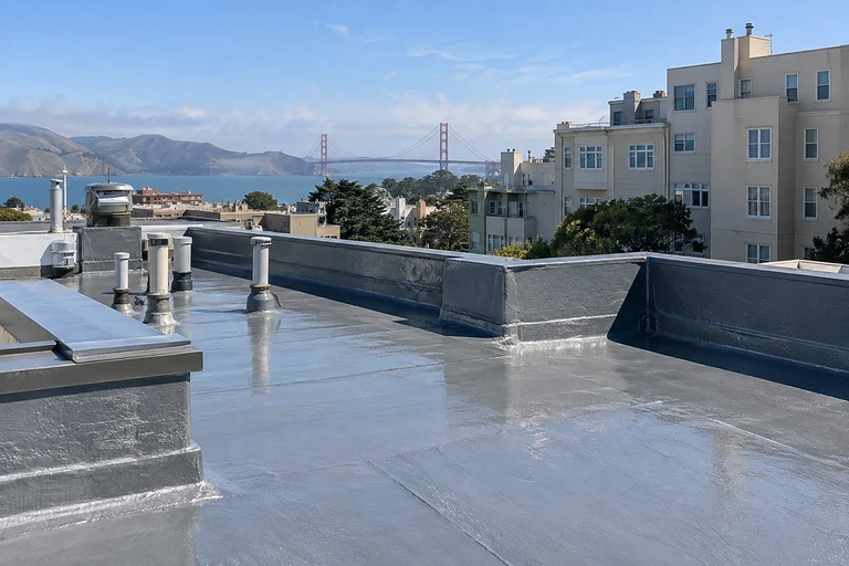 Waterproofing and restoration San Francisco — coated commercial roof with vent penetrations and parapet flashing