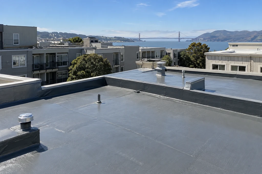 Waterproofing companies San Francisco — freshly coated low-slope roof deck with parapet and the Golden Gate behind