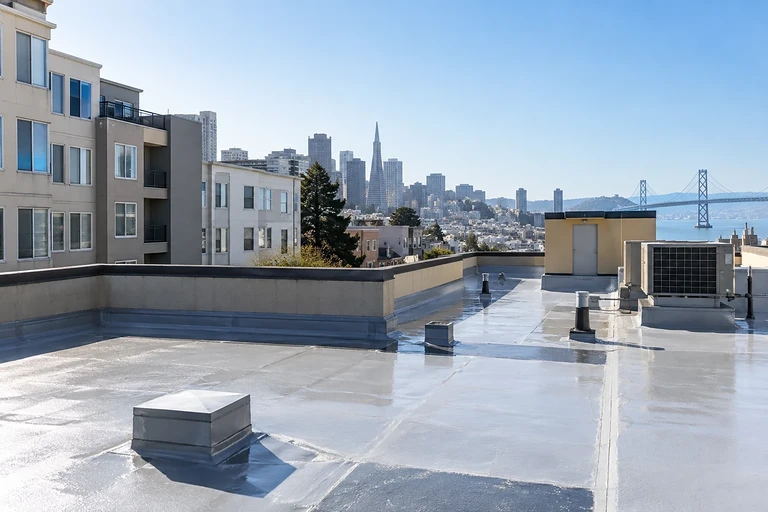 Waterproofing San Francisco — coated roof deck with mechanical units above an older apartment building