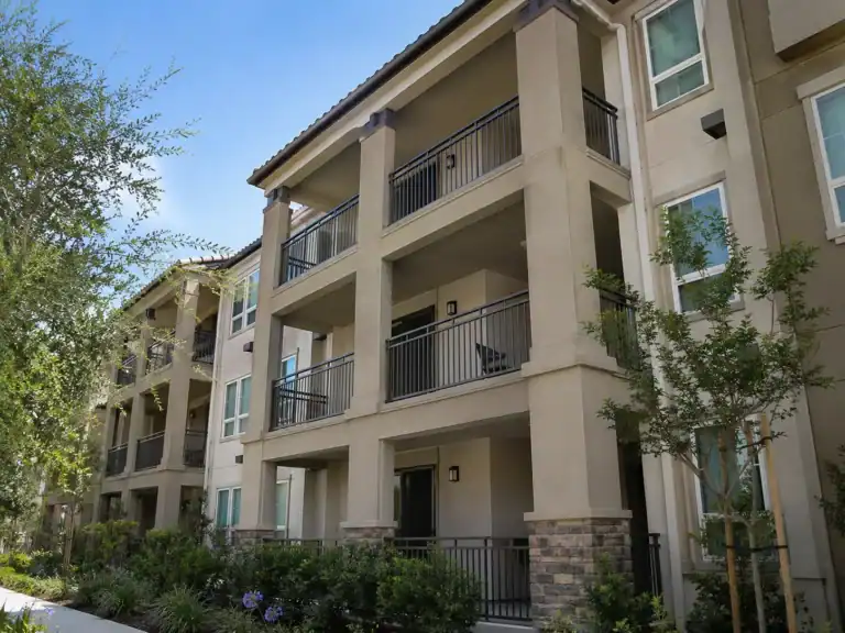 Stacked covered balconies on an apartment building, each shaded by the balcony above