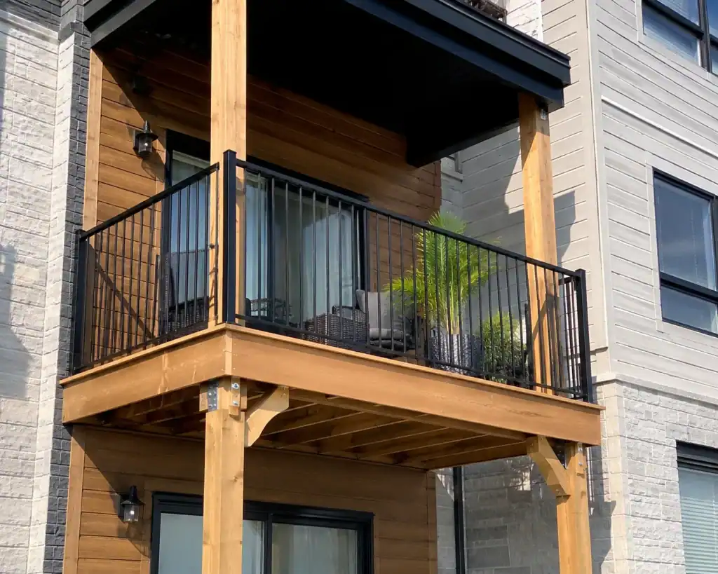 Balcony installed on timber posts with metal connectors, on a multi-storey building
