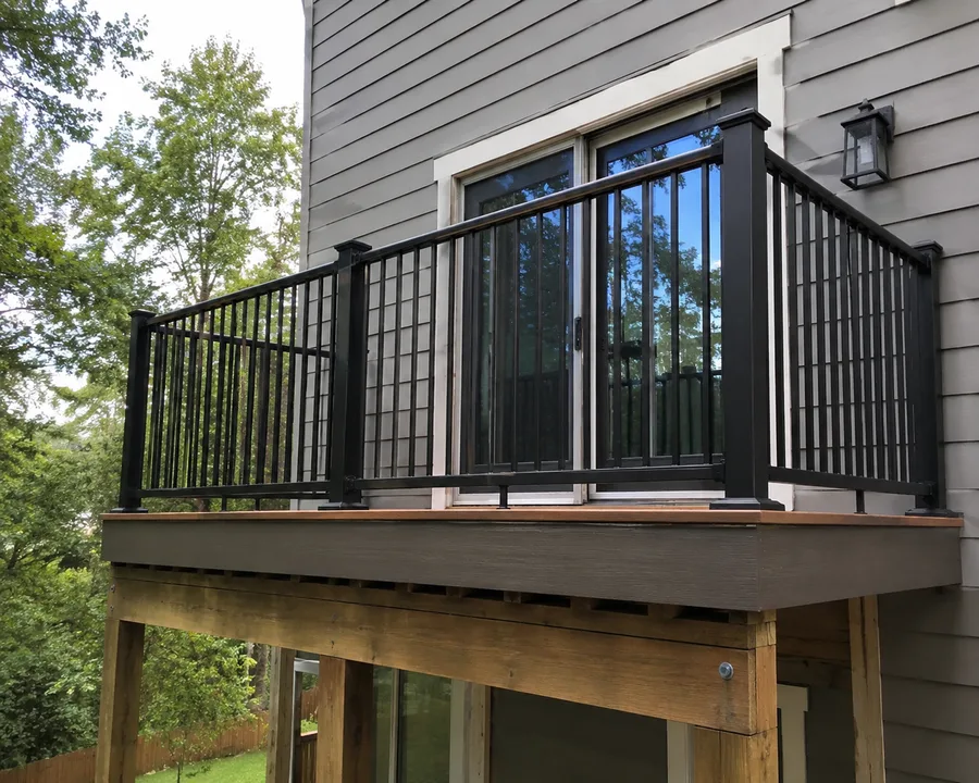 Newly installed balcony with aluminum picket guardrails on a post-supported frame