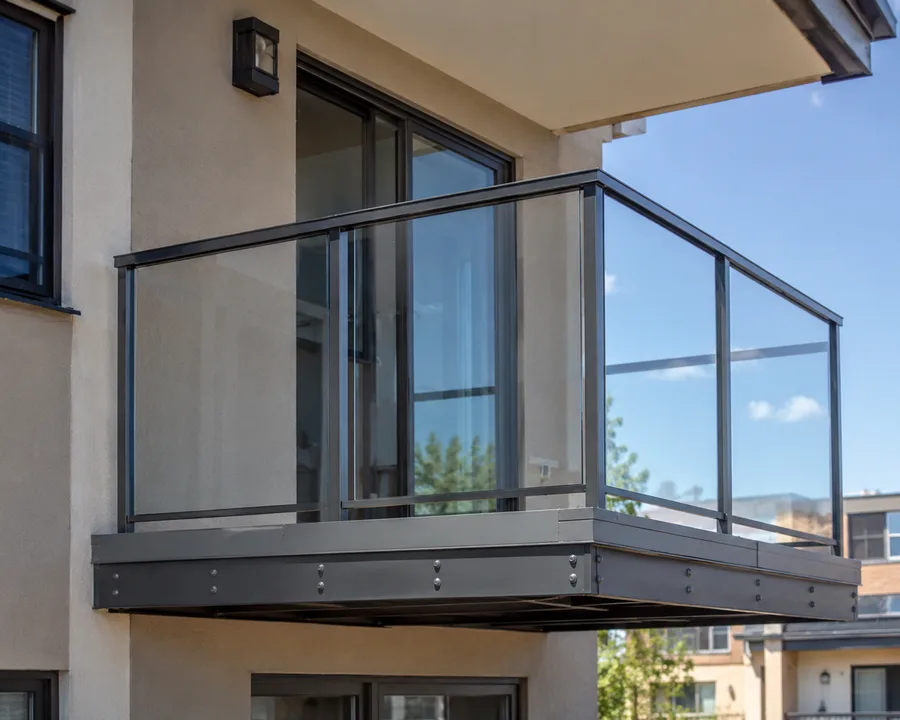 Cantilevered steel-framed balcony bolted into the building wall, with no supporting posts