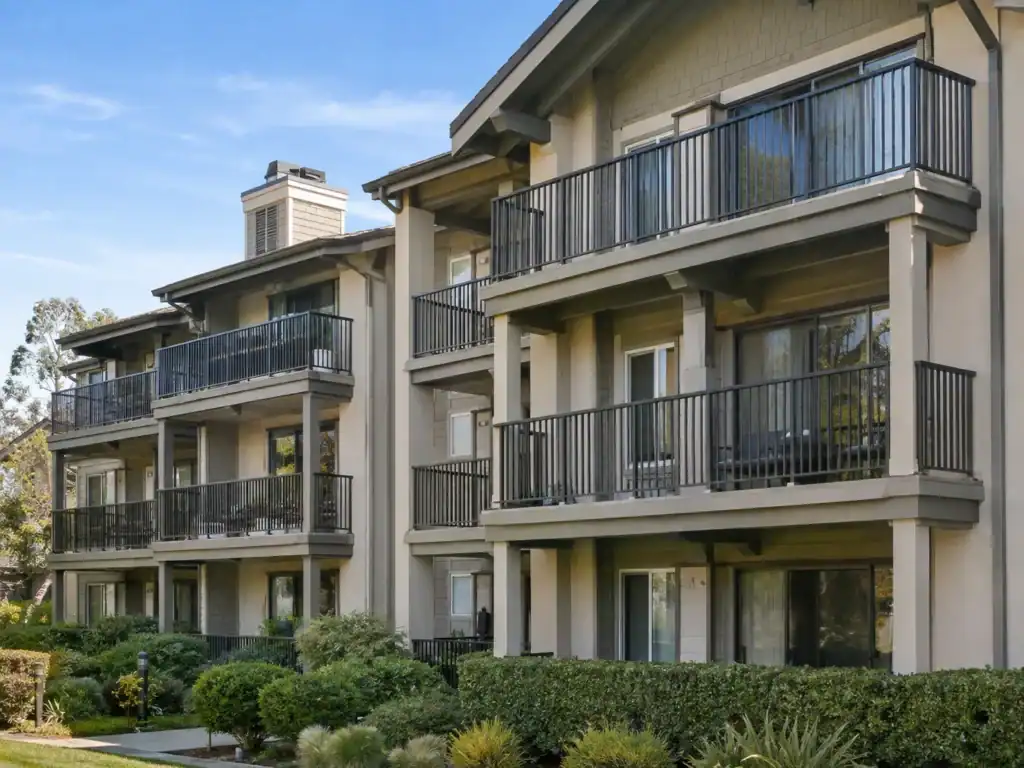Apartment community with metal balcony guardrails on every unit across three floors