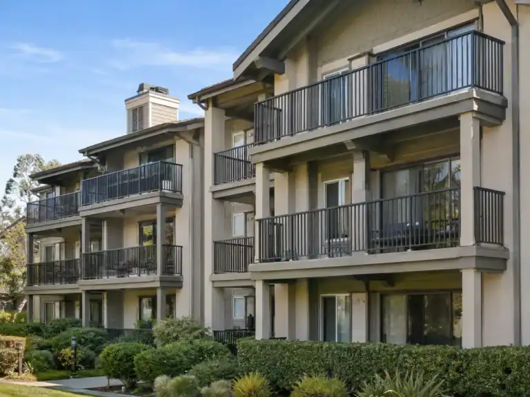 Apartment community with metal balcony guardrails on every unit across three floors