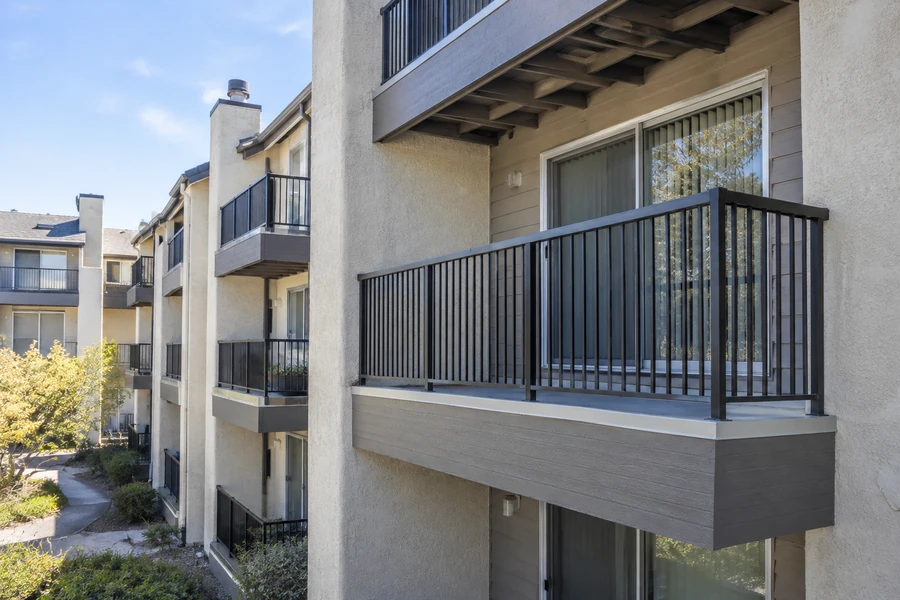 Close view of a renovated balcony with new fascia, new surface and new metal guardrail