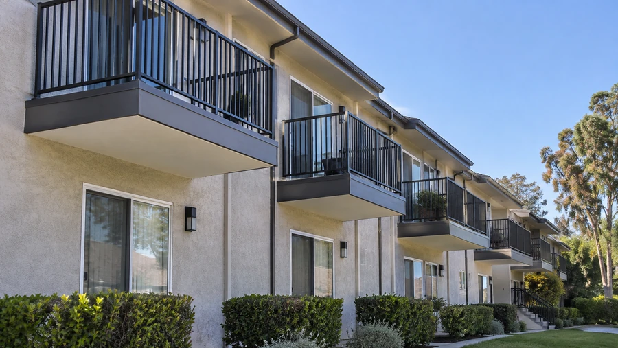 Apartment elevation after balcony replacement, with new guardrails and refinished soffits throughout