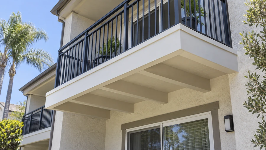 Restored balcony with a smooth rendered underside and repainted metal guardrail