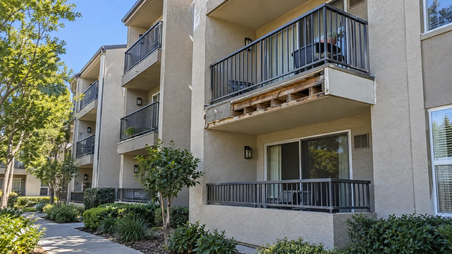 Apartment elevation with one balcony edge opened to the framing during restoration