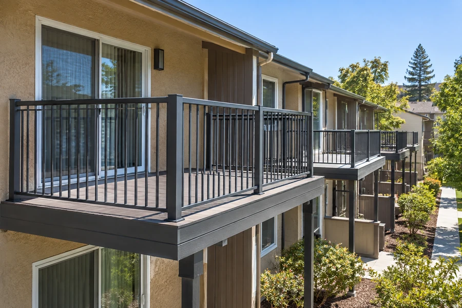 Restored balcony with a new composite surface and black aluminium guardrail