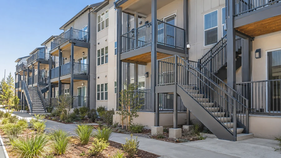 Balcony stairs and landings integrated into the balcony structure across a three-storey building