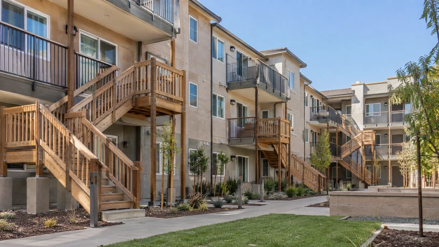 Timber balcony staircases with intermediate landings serving upper-floor balconies