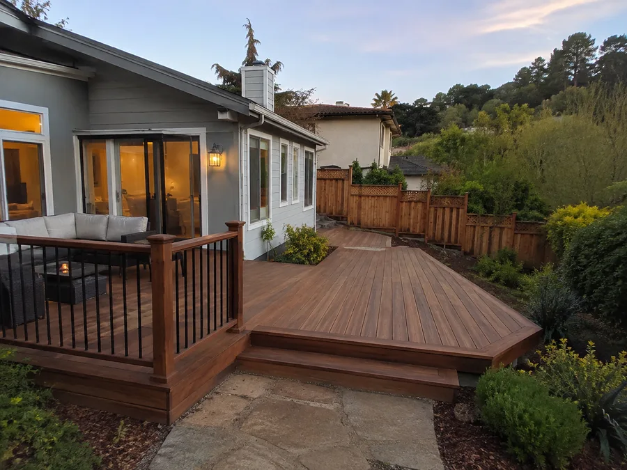Extended deck with a wide lower section stepping down to a stone path