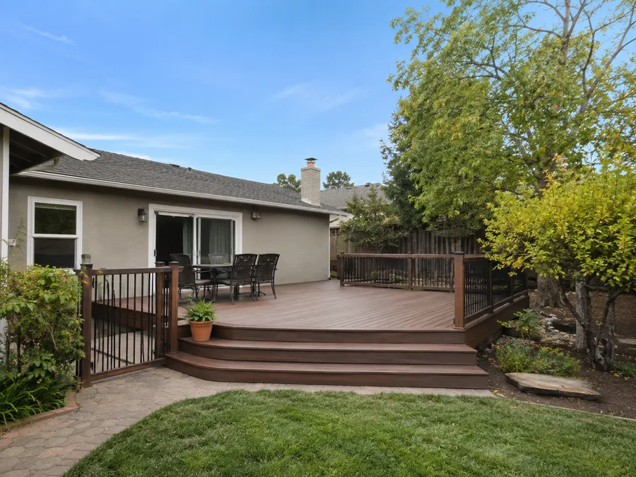 Completed extended deck with cascading steps and a gate to the side path