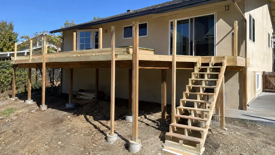Extension framing and a new stair run built out from an elevated deck