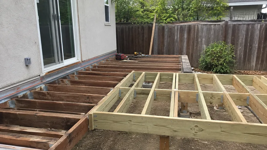 New framing built alongside the stripped original structure during a rebuild