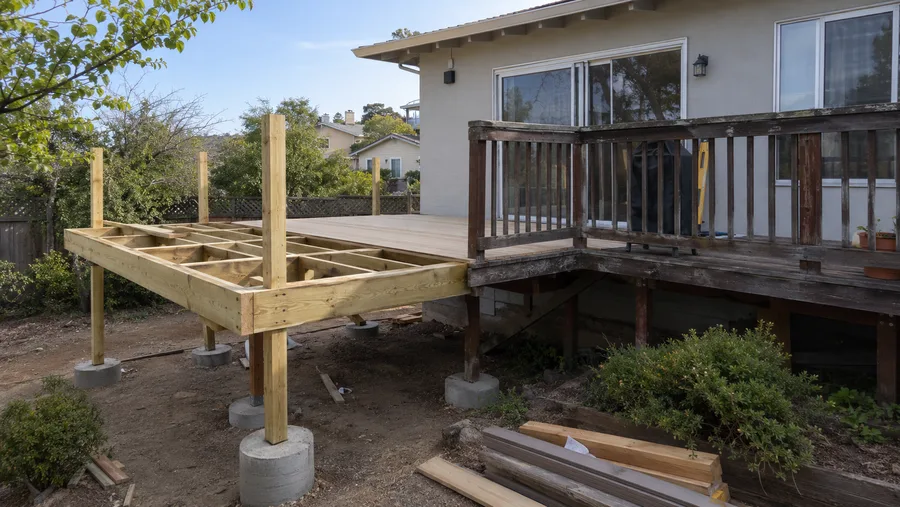 Rebuild in progress with new posts on concrete piers extending the structure